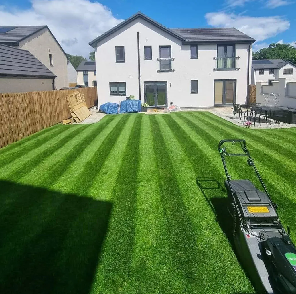 Weekly cut underway on a rear garden lawn