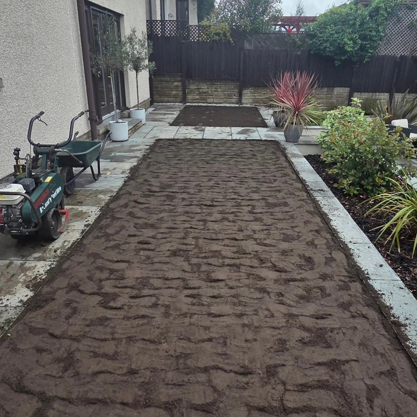 Rootzone spread and levelled across the lawn panels in a Kirkliston garden