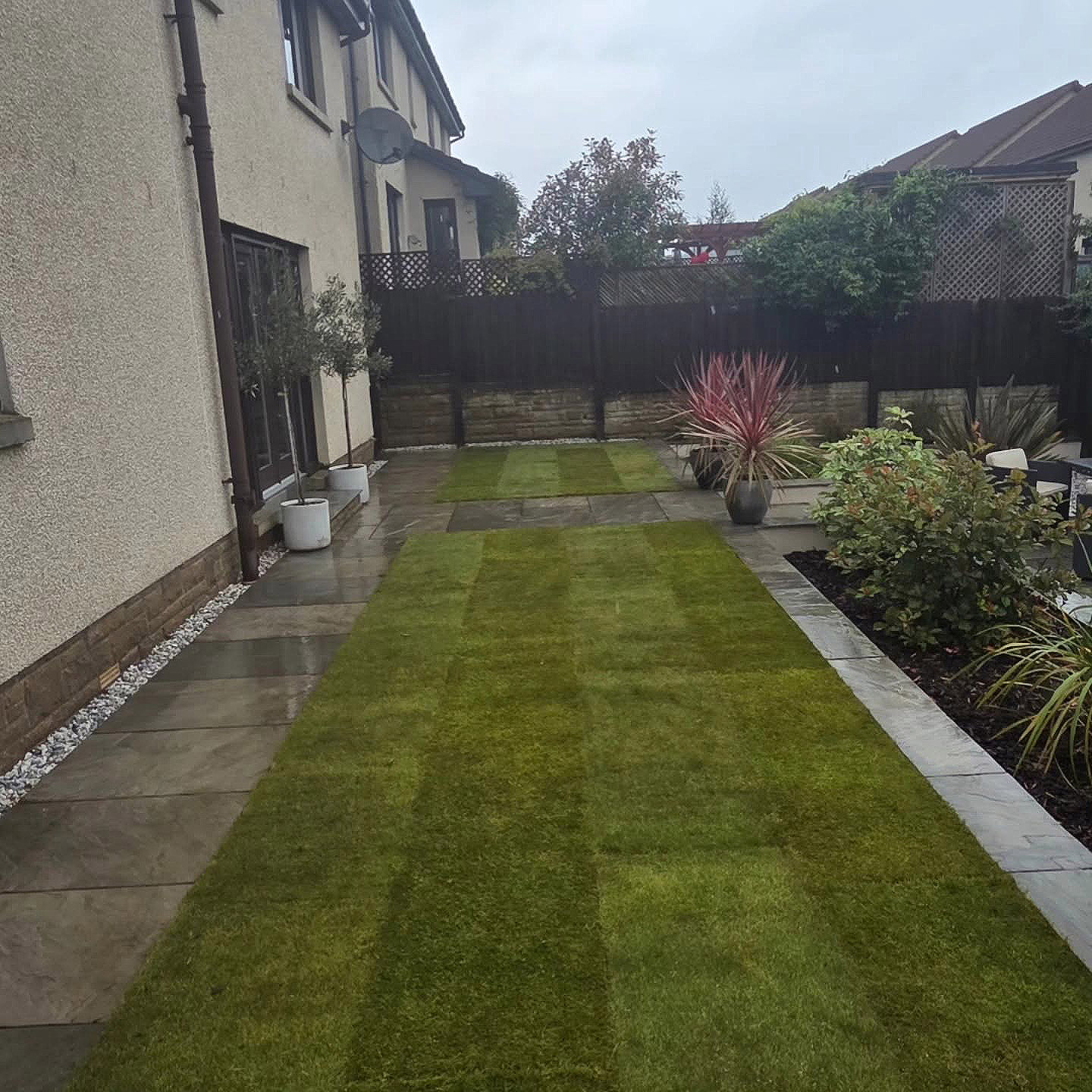 Fresh premium turf laid across a Kirkliston garden's lawn panels