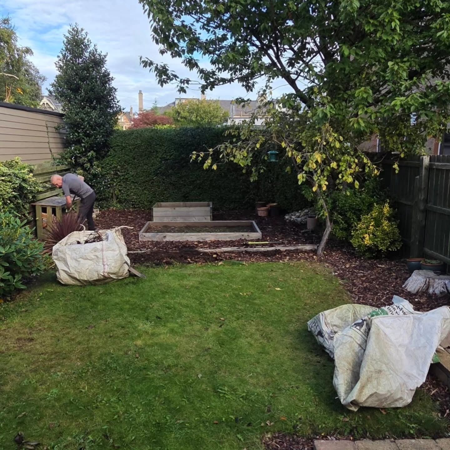 Small back garden in Trinity with the old lawn, planters and sleepers, before DSM started