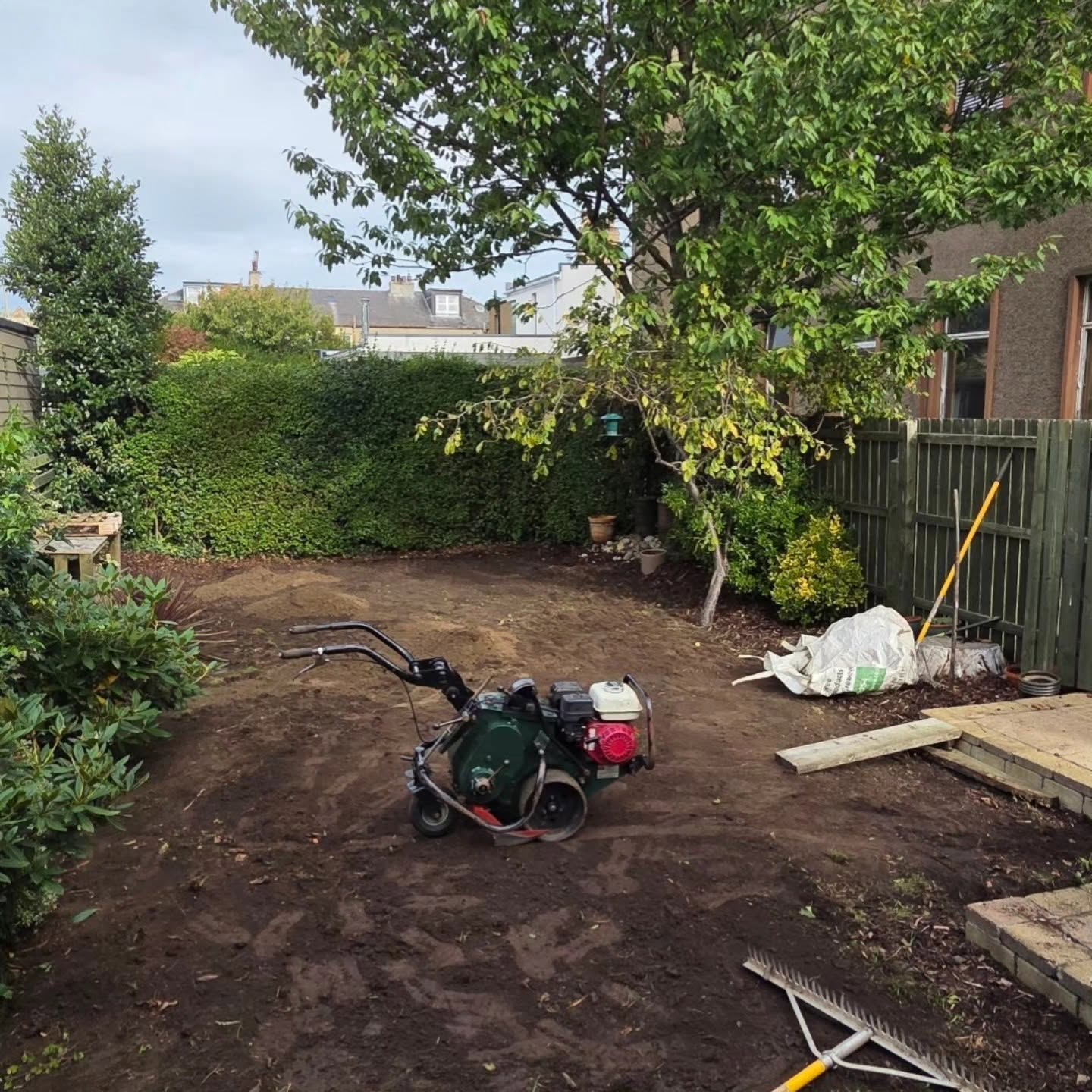 The old Trinity lawn ripped up with a rotavator, planters and sleepers gone